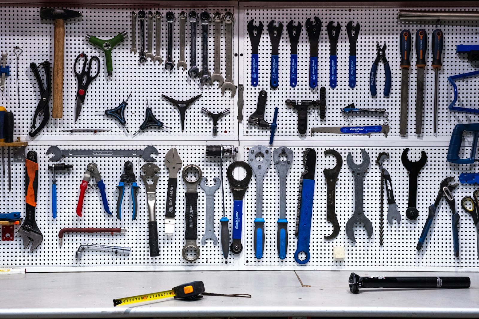 A wall of organized hand tools — function calling is the API by which the model picks which tool to use